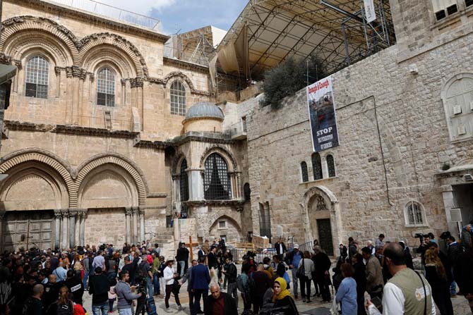 Pilgrims and journalists gather in the yard of the Church of the Holy Sepulchre in Jerusalem