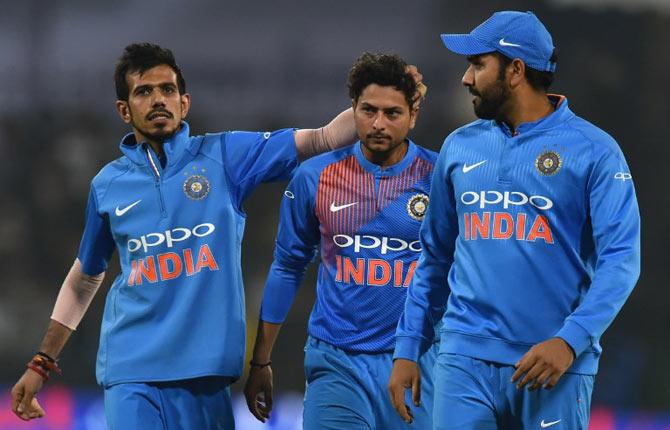 Yuzvendra Chahal, Kuldeep Yadav and Rohit Sharma. Pic/AFP