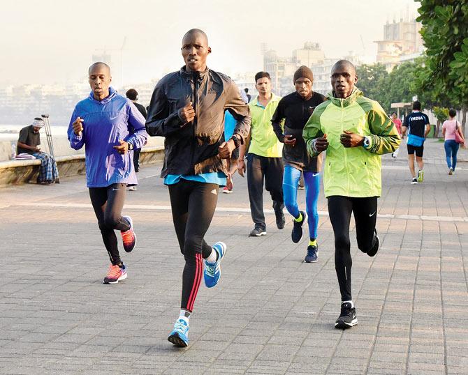 Foreign runners train on the eve of the Mumbai Marathon at Marine Drive on Saturday. Pic/Suresh Karkera