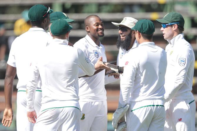 South African bowler Andile Pehlukwayo (C) celebrates with his teammates the dismissal of Indian batsman Cheteshwar Pujara (not in picture) during the first day of the third test match between South Africa and India at Wanderers cricket ground on January 24, 2018 in Johannesburg. Pic/AFP