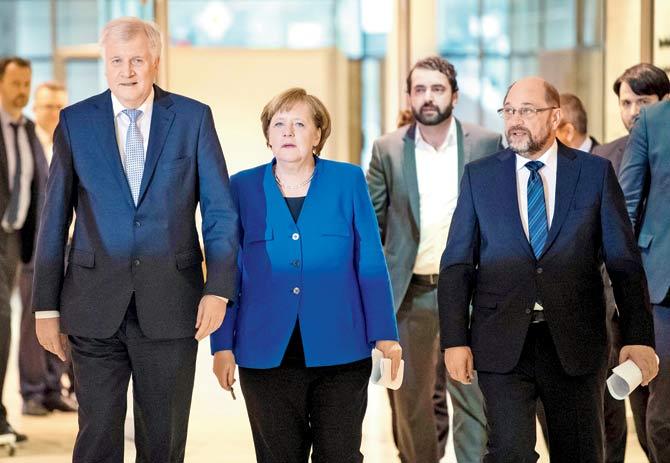 (L-R) State Premier for Bavaria, Horst Seehofer; German Chancellor Angela Merkel and leader of the Social Democratic Party Martin Schulz arrive at a press conference after talks to form a new government, at the SPD headquarters in Berlin. Pic/AFP
