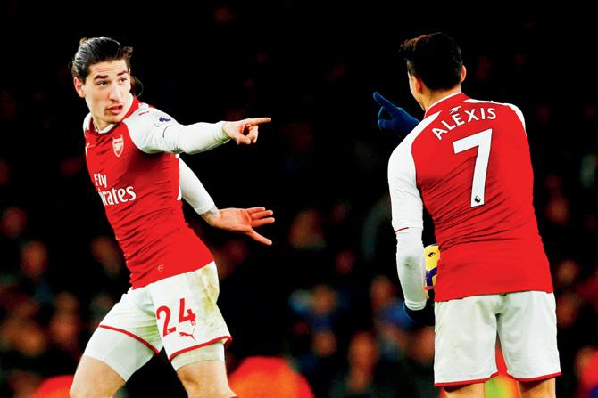 Arsenals Hector Bellerin (left) celebrates a goal with teammate Alexis Sanchez during an EPL tie v Chelsea on Wednesday. Pic/AFP