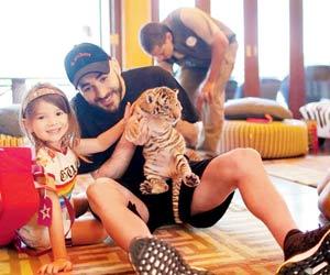 Footballer Karim Benzema slammed for letting daughter play with baby tiger