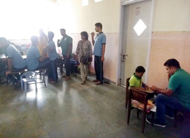 With classrooms locked, teachers conducted classes in the corridor on Tuesday