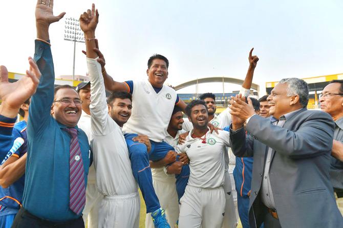 Vidarbha players celebrate with their coach Chandrakant Pandit after winning the Ranji Trophy final cricket match against Delhi by 9 wickets, in Indore on Monday. Pic/PTI