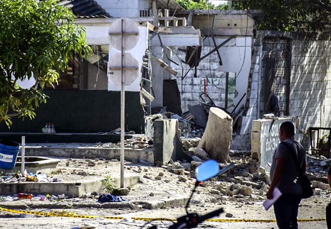 A man walks in front a police station after a bomb attack where 5 died and 41 are wounded in Soledad Atlantico Dapartment, Colombia. Pic/AFP