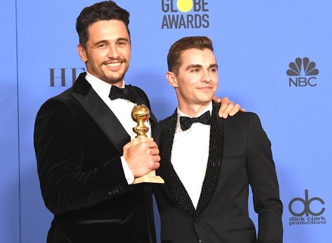 Dave Franco (R) poses with James Francoand his award for Best Performance by an Actor in a Motion Picture Musical or Comedy in 