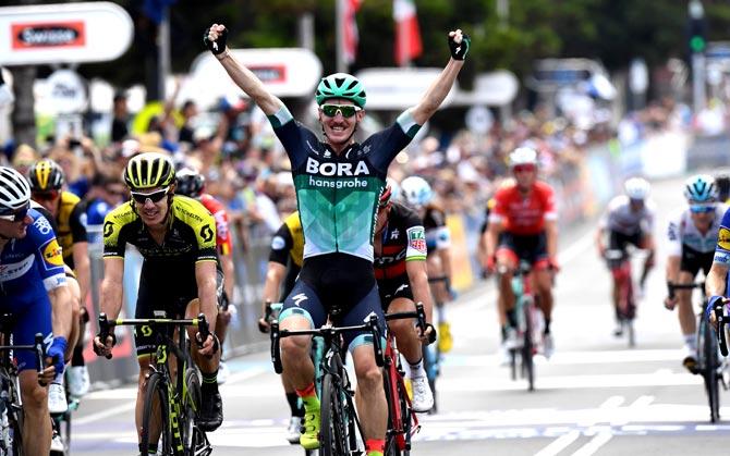 Australian rider Jay McCarthy of Bora-Hansgrohe (C) celebrates as he wins the Cadel Evans Great Ocean Road cycling race in Geelong. Pic/AFP