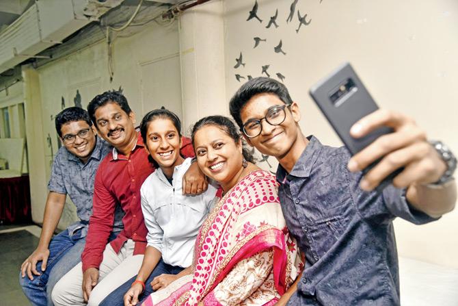 Jemimah Rodrigues (centre), flanked by her father, Ivan, and mother, Lavita with brothers, Enoch (left)  and Eli, enjoys a selfie moment at Rang Sharda in Bandra yesterday. pic/ PRADEEP DHIVAR 