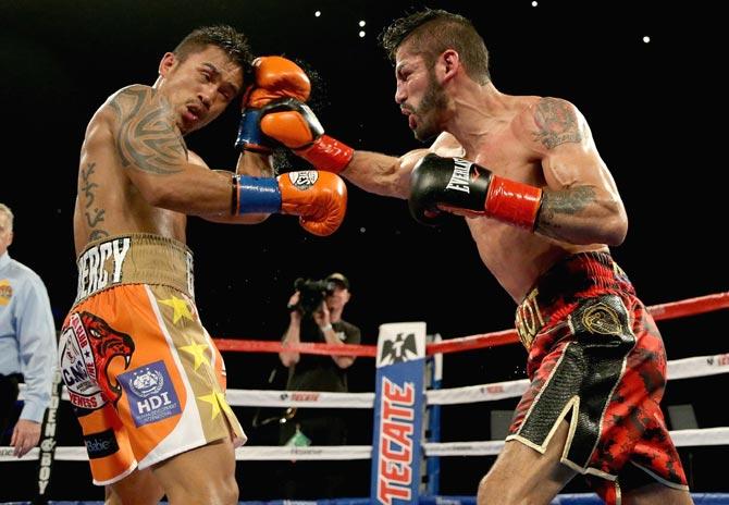 Jorge Linares (R) of Venezuela throws a right hand at Mercito Gesta during their bout at The Forum in Inglewood. Pic/AFP