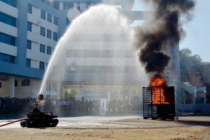 Firefighters put out an LPG cylinder fire, which is a major risk in slums