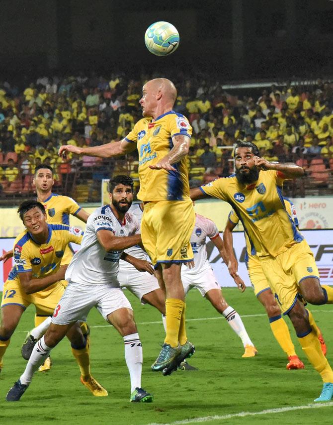 Players of Kerala Blasters FC (Yellow Jersey) and Delhi Dynamos FC in action during the 4th season of Indian Super League ISL match at Jawaharlal Nehru International Stadium in Kochi on Saturday. Pic/ PTI 