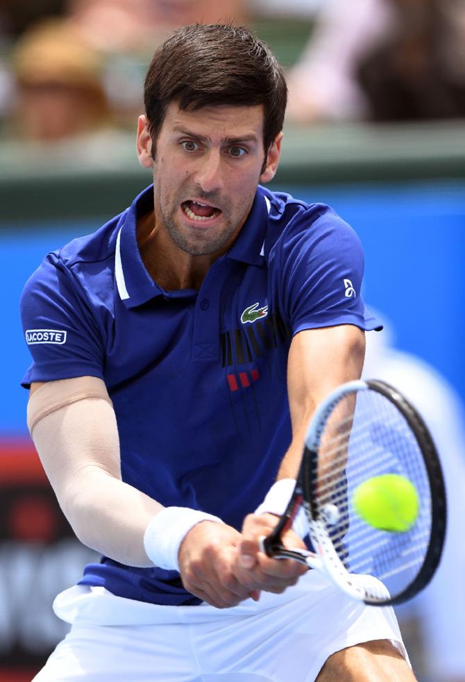 Novak Djokovic of Serbia hits a return during his match against Dominic Thiem of Austria at Kooyong Classic tennis tournament in Melbourne on January 10, 2018. / AFP