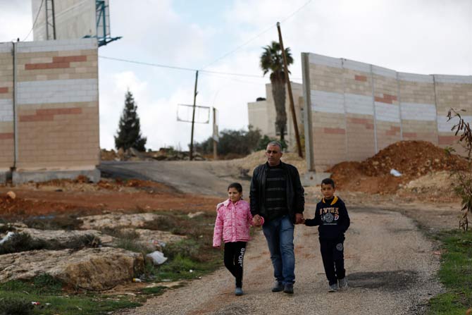 Palestinian Jumaa family, whose house became encircled by Israel