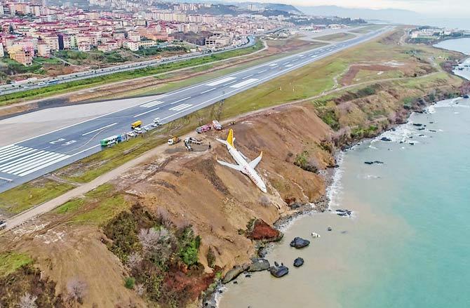 A Pegasus Airlines Boing 737 passenger plane is seen struck in mud on an embankment, a day after skidding off the airstrip, after landing at Trabzon