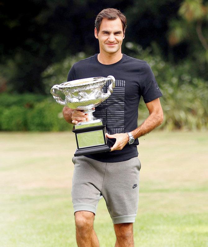 Switzerlands Roger Federer with the Norman Brookes Challenge Cup, his reward for winning the Australian Open men’s singles final, at Government House in Melbourne yesterday.  PIC/Getty Images 