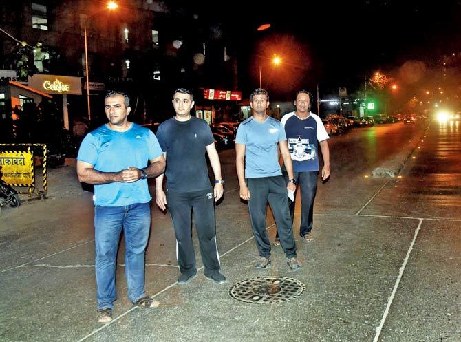 (From left) Residents Saqueeb Jariwala, Afzal Choudhary, Ahmad Namazi and Cyril Dara point to a spot where the bike accident had taken place a month ago