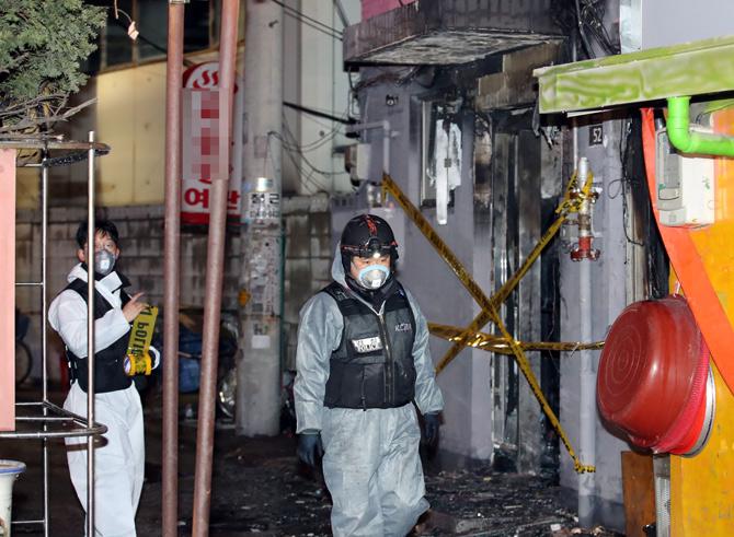 Forensic workers examine the site of a fatal arson attack in central Seoul on January 20, 2018. Five people were killed and four others were hospitalised in an arson attack on a motel in downtown Seoul, police said. Pic/AFP 