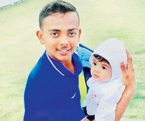 Who's baby is Prithvi Shaw carrying?