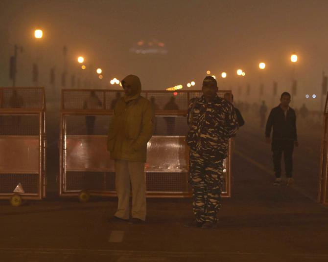 Security personnel guard at Rajpath near India Gate, during a cold day in New Delhi on Tuesday. Pic/PTI