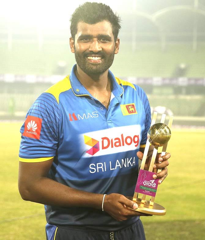 Sri Lankan cricketer Thisara Perera holds a trophy after five wickets victory against Zimbabwe during the Fourth One Day International (ODI) cricket match in the Tri-Nations Series between Sri Lanka and Zimbabwe at the Sher-e-Bangla National Cricket Stadium in Dhaka. Pic/AFP