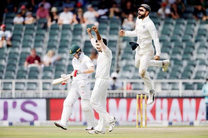 India captain Virat Kohli (right) jumps in joy as pacer Jasprit Bumrah celebrates the dismissal of South African batsman AB de Villiers at the Wanderers in Johannesburg on Saturday. PIC/AFP 