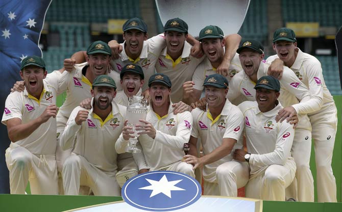 Australian players celebrate their win over England on the last day of their Ashes cricket test match in Sydney