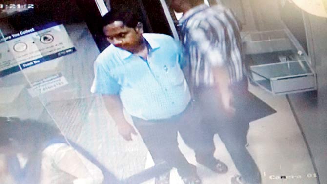 CCTV footage of the two conmen inside the ATM