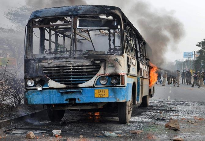 A Haryana roadways bus set on fire by alleged activists of the Karni Sena, at NH-248 during a demonstration against the release of 