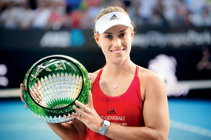 Angelique Kerber holds the winners trophy in Sydney on Saturday. PIC/AFP