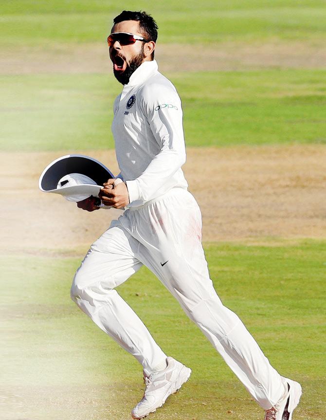 India skipper Virat Kohli celebrates after taking a catch at slips to dismiss SA batsman Quinton de Kock on Day One of the second Test at Centurion on Saturday. Pic/AP/PTI