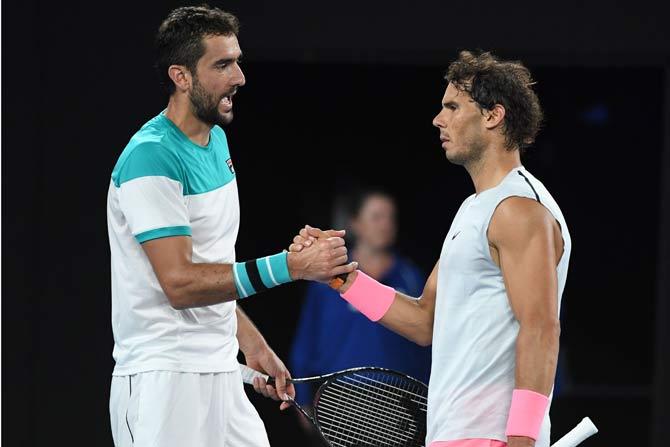 Marin Cilic shakes hands with Rafael Nadal after Nadal retired from their Australian Open quarter-finals match. Pic/ AFP Photo