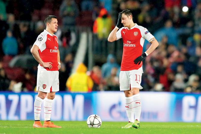 Arsenal midfielder Alexis Sanchez (left) and winger Mesut Ozil’s contracts are set to expire at the end of the current season. Pic/Getty Images