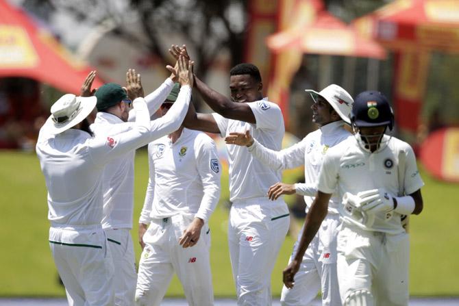 Lungi Ngidi (3rd R) celebrates the dismissal of Indian batsman Hardik Pandya (R) during the fifth day 