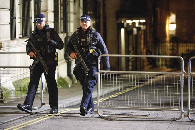 Armed police officers patrol in Westminster, ahead of the New Year