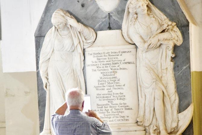 A visitor reads a plaque