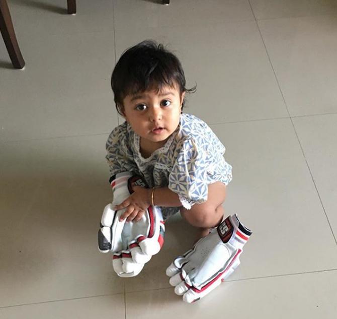 Another cute picture Naman Ojha shared with his little one on Instagram. While Aanya tried on her father's batting gloves, Naman Ojha tried to figure out what's on her mind, he quoted Hey  I'm the first one to see Daddy's new stuff when they arrive #daddysnewgloves #iamsohappy #babyaanya