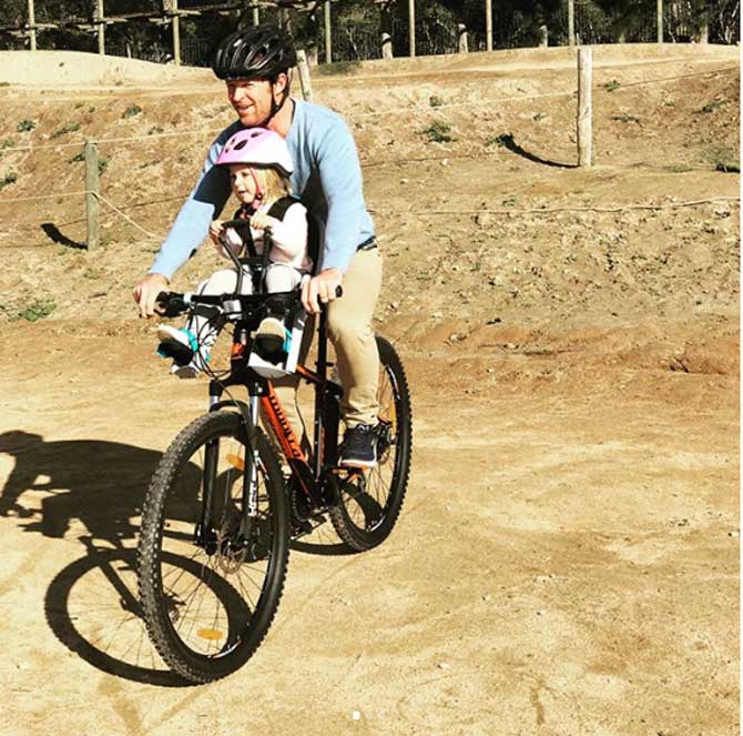 In picture: Rhodes seen biking in South Africa with his daughter India Rhodes.