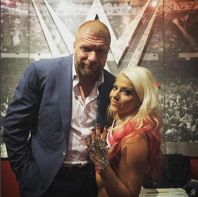 Triple H with one of the hottest WWE women wrestlers and former SmackDown Women's champion Alexa Bliss.