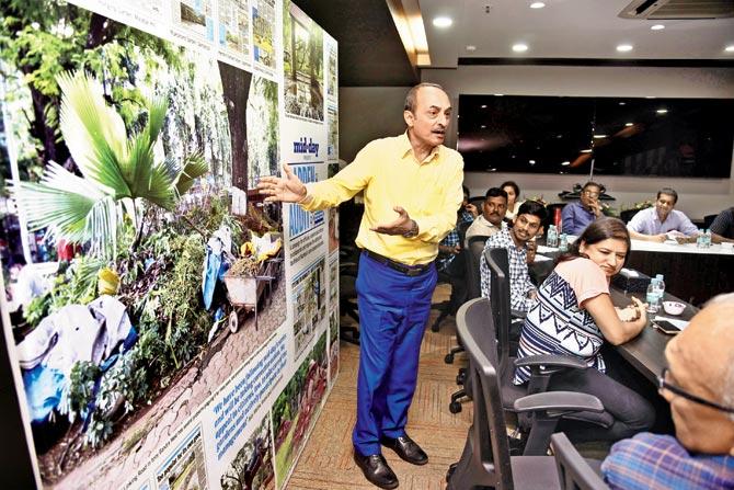 Activist Sunil Khosla points to a photo of Linking Road