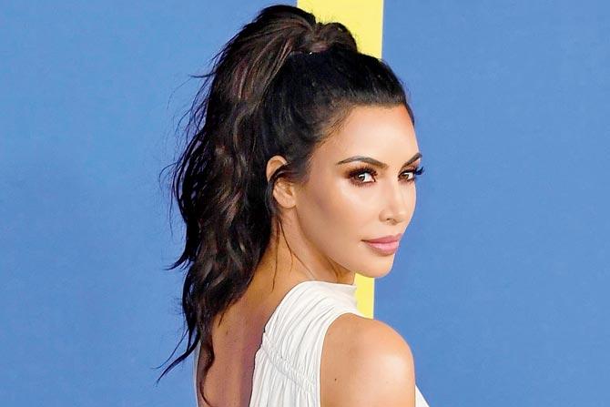 Kim Kardashian makes the look wispy by leaving a few strands out.