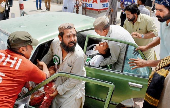 At least 31 people, including policemen, were killed after a suicide bomber blew himself up in Quetta. Pics/AFP and AP