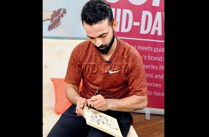 Ajinkya Rahane autographs a mid-day diary at the event