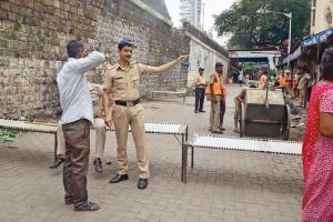 A policeman gives alternate directions to a pedestrian as the Delisle bridge is shut. Pic/Atul Kamble