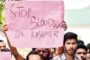 Kashmir University students raise slogans to protest killing of three civilians in firing by security forces at Kulgam on Sunday. Pic/PTI