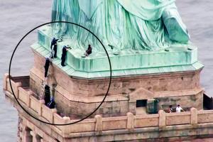 Woman scales Statue of Liberty to protest Trump's immigration policy