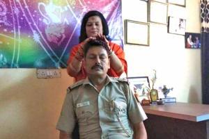 Cop gets a transfer after his photo with god woman goes viral