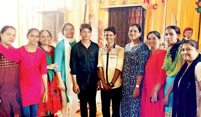 Dashrath Pawar and Mohan Kale (centre) pose with teachers from the Signal school