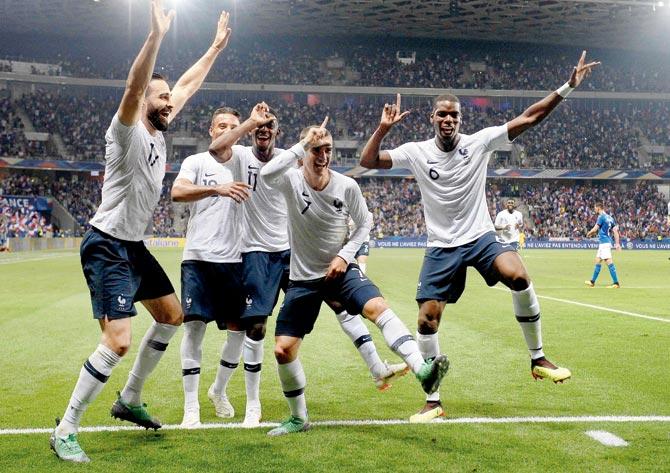 France striker Griezmann (centre) celebrates his goal with teammates