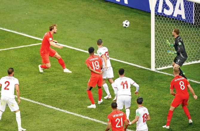 Harry Kane (left) heads to score in injury time